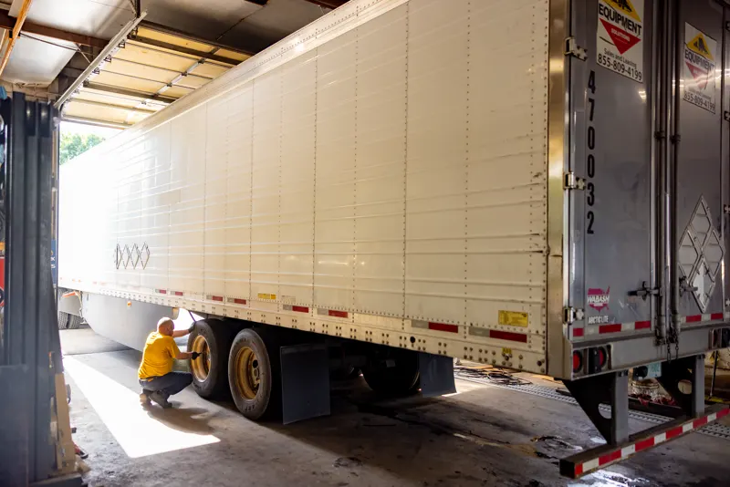 Trailer being serviced inside a bay